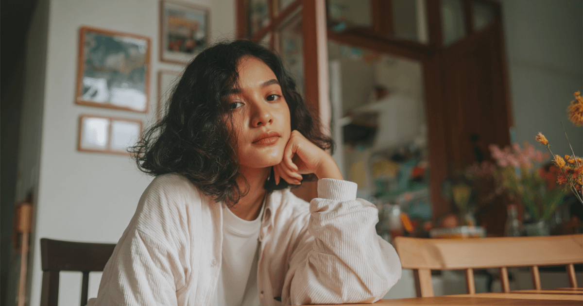 Worried nanny sitting at a kitchen table, unsure about job expectations.